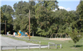 A Small Playground and Swingset Beside a Parking Lot at the Marple Gradens