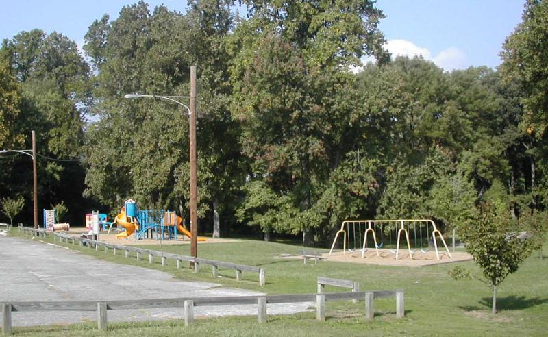 A Small Playground and Swingset Beside a Parking Lot at the Marple Gradens
